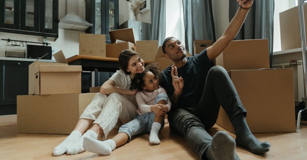 pexels-photo-4569901-4569901 A happy family takes a selfie amidst moving boxes in their new apartment.