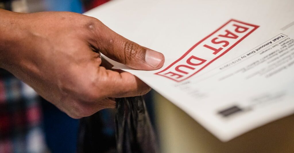 pexels-photo-7926666-7926666 A close-up of a hand holding a document with a 'Past Due' stamp, highlighting financial urgency.